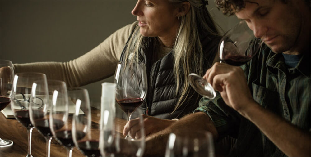 Customers tasting and sniffing wine at a wine tasting